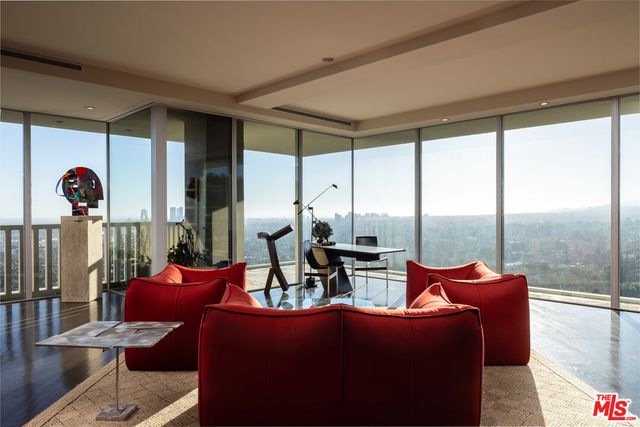 a living room with furniture a floor to ceiling window and couch