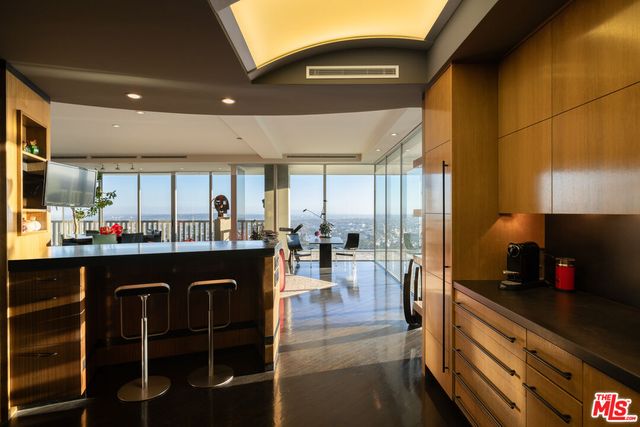 a kitchen with granite countertop a stove a sink and a refrigerator