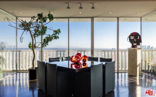 a living room with furniture flowerpot and wooden floor