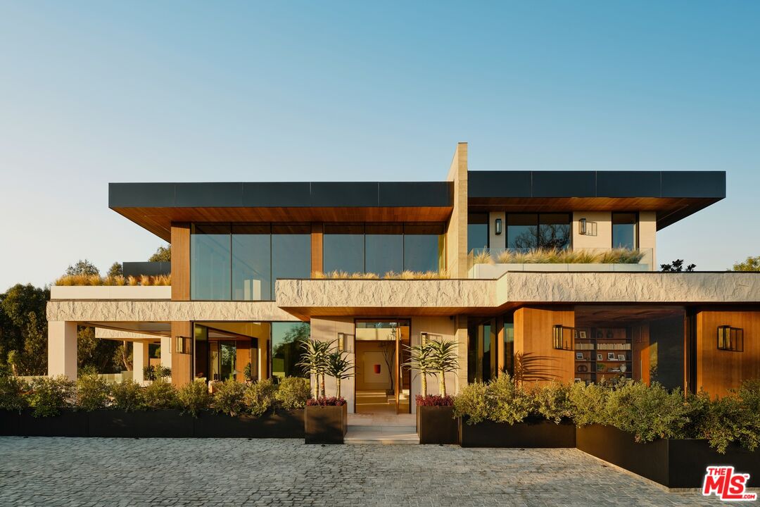 401 North Tigertail Road Los Angeles, CA 90049 - Photo 1 of 41 a front view of a house with garden