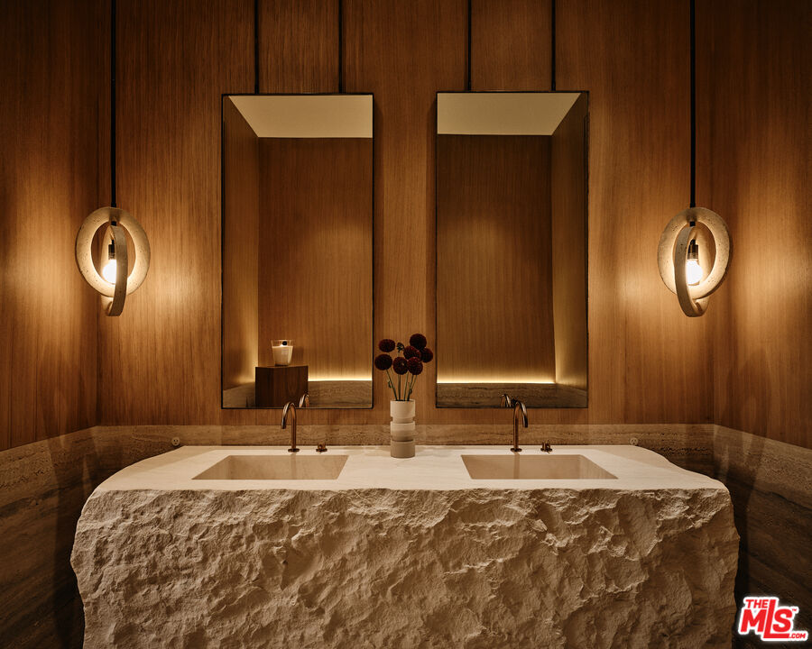 401 North Tigertail Road Los Angeles, CA 90049 - Photo 15 of 41 a bathroom with double vanity sinks and a mirror