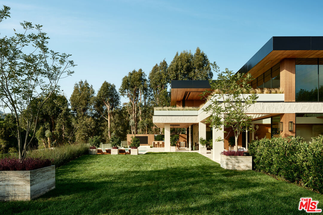 401 North Tigertail Road Los Angeles, CA 90049 - Photo 2 of 41 a front view of a house with a yard