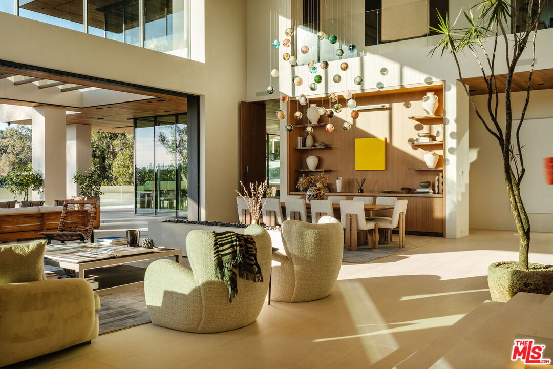 401 North Tigertail Road Los Angeles, CA 90049 - Photo 3 of 41 a living room with fireplace furniture and a large window