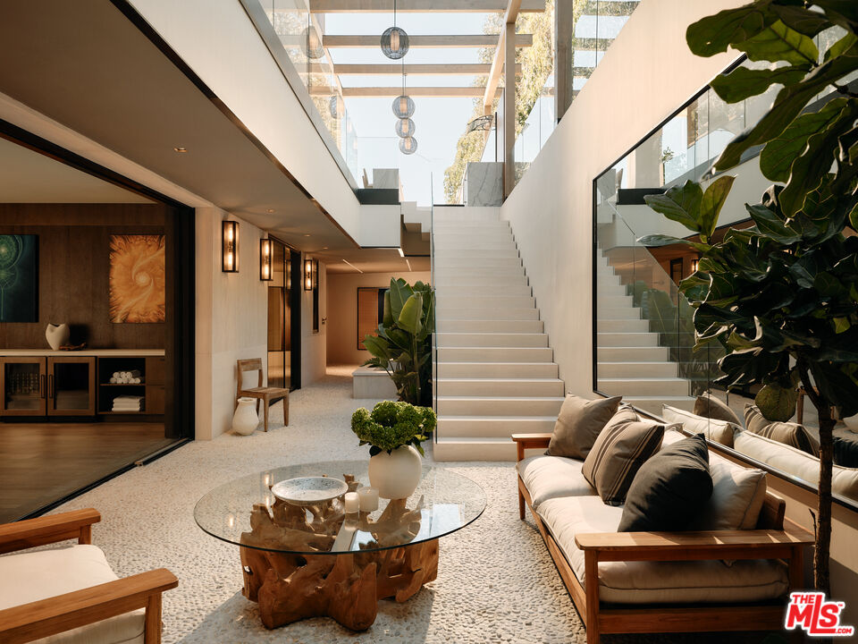 401 North Tigertail Road Los Angeles, CA 90049 - Photo 32 of 41 a living room with furniture and a potted plant