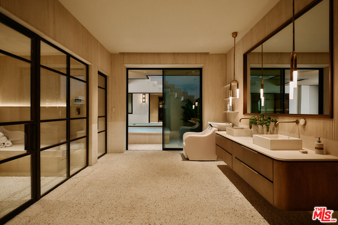 401 North Tigertail Road Los Angeles, CA 90049 - Photo 34 of 41 a spacious bathroom with a double vanity sink and a large mirror