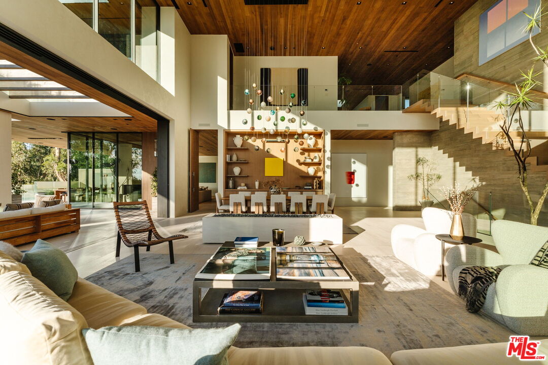 401 North Tigertail Road Los Angeles, CA 90049 - Photo 4 of 41 a living room with furniture and a chandelier