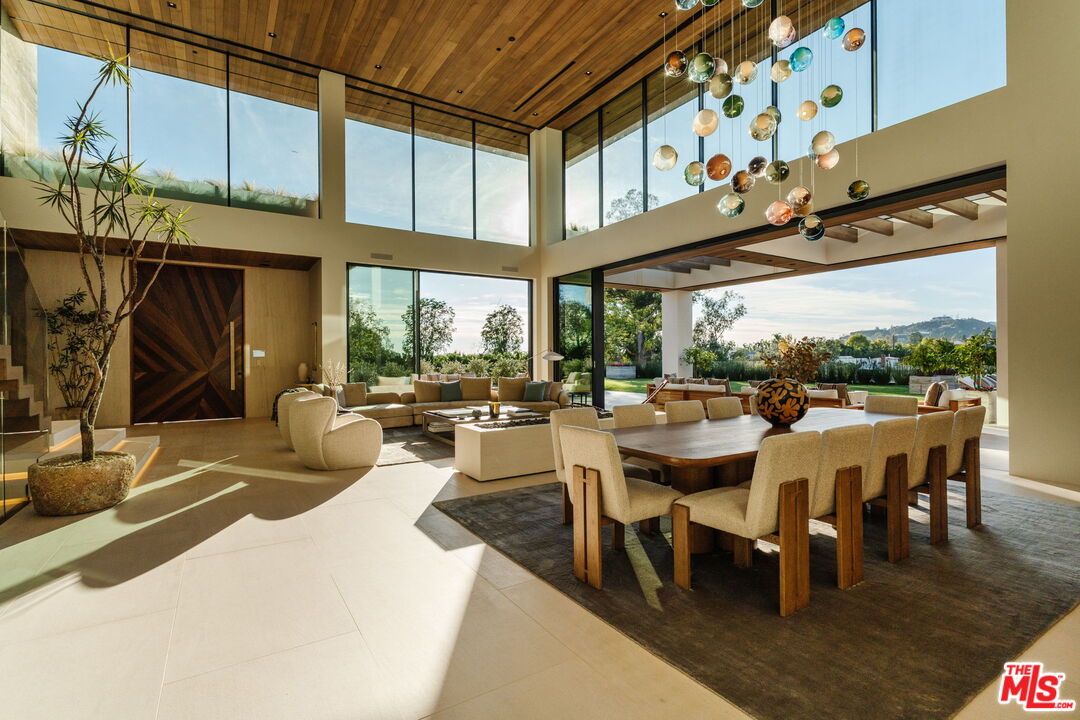 401 North Tigertail Road Los Angeles, CA 90049 - Photo 5 of 41 a view of a patio with dining table and chairs