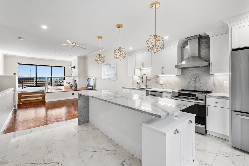 32 Shipway Place, Unit 32 Boston, MA 02129 - Photo 1 of 19 a kitchen with stainless steel appliances granite countertop a sink stove and refrigerator