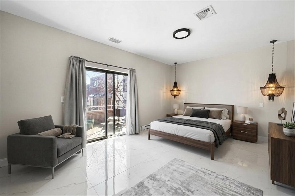 32 Shipway Place, Unit 32 Boston, MA 02129 - Photo 12 of 19 a bedroom with furniture and a large window