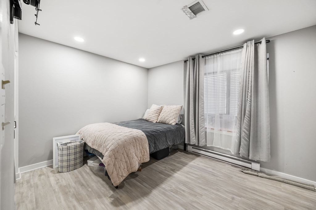 32 Shipway Place, Unit 32 Boston, MA 02129 - Photo 16 of 19 a bedroom with a bed and a mirror