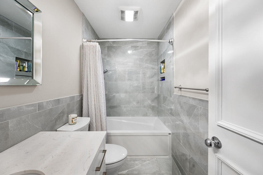 32 Shipway Place, Unit 32 Boston, MA 02129 - Photo 17 of 19 a bathroom with a bathtub shower and toilet