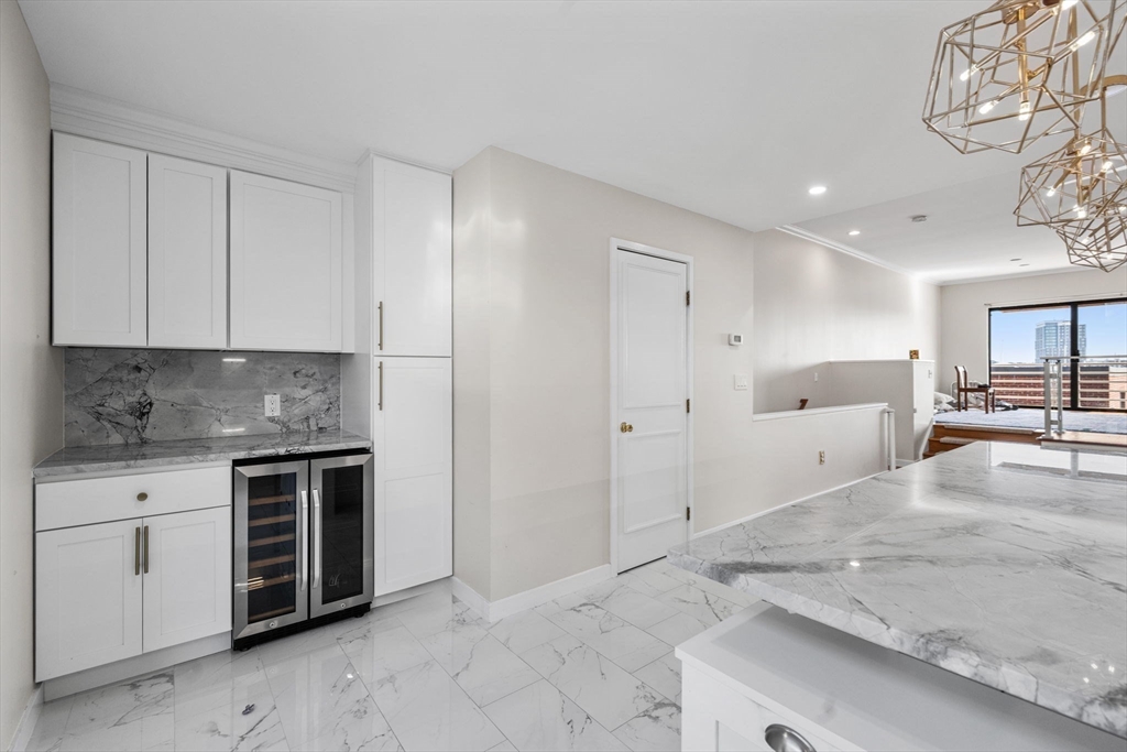 32 Shipway Place, Unit 32 Boston, MA 02129 - Photo 8 of 19 a large white kitchen with a stove a sink a refrigerator and cabinets