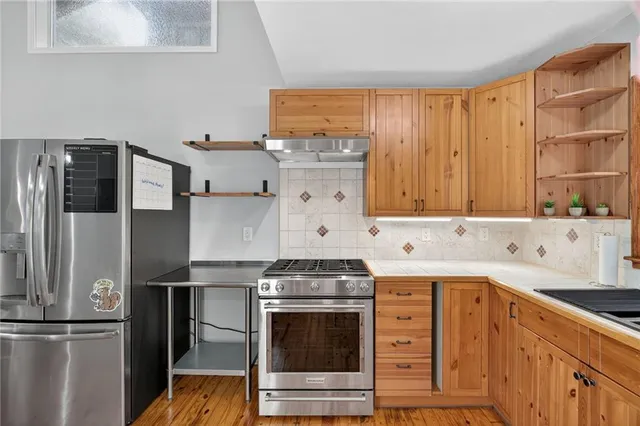 a kitchen with stainless steel appliances a stove and a refrigerator