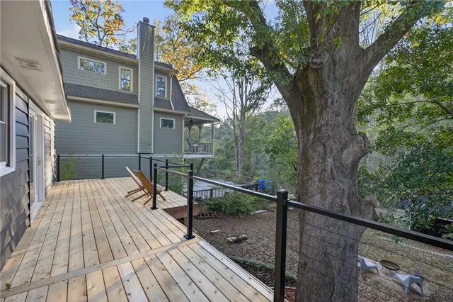a view of a house with backyard and deck