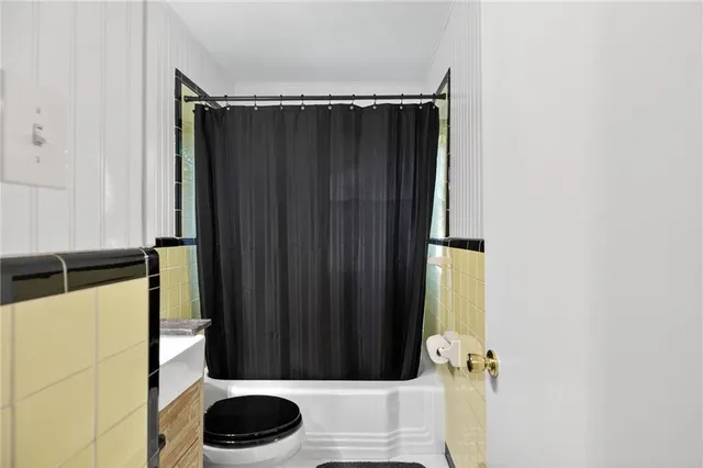 a bathroom with a bathtub and shower