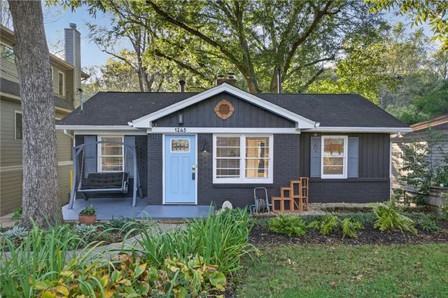 a front view of a house with yard and green space