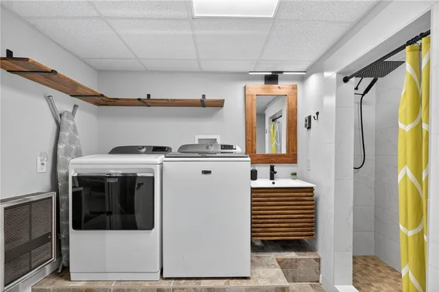 a bathroom with a granite countertop toilet and a sink