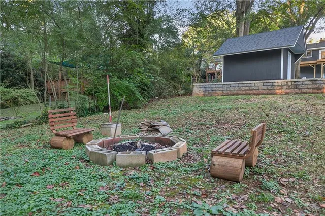 a view of a backyard with a table and chairs