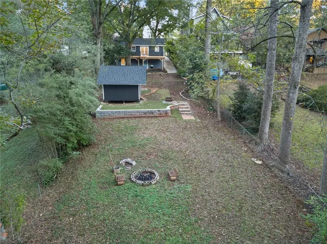 a view of a chair and table in the backyard