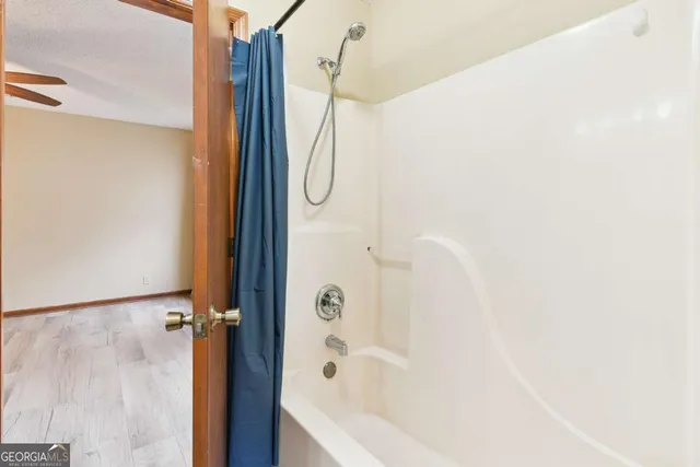 a bathroom with a bathtub and a shower