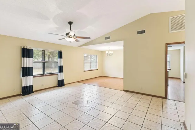a view of a kitchen with a sink and a refrigerator