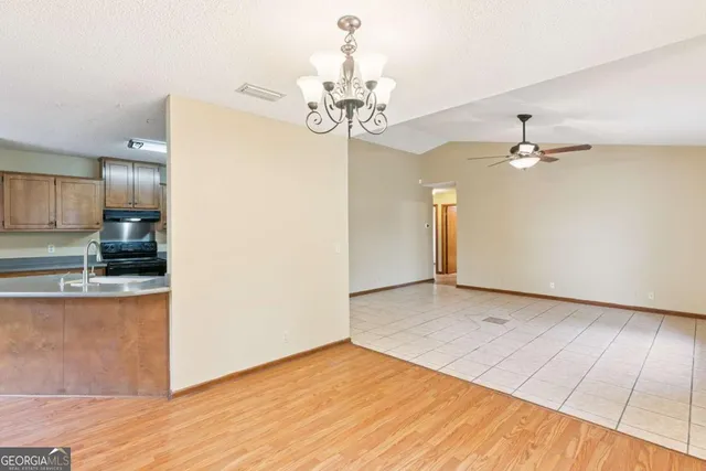 a view of a kitchen with wooden floor and a kitchen counter top space