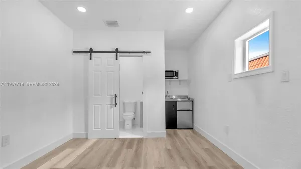 a view of a kitchen with electric appliances