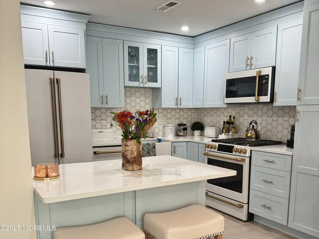 a kitchen with stainless steel appliances a sink dishwasher stove and refrigerator