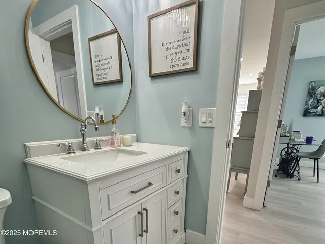 a bathroom with a sink mirror and vanity