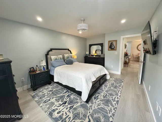 a bedroom with a large bed and a flat screen tv