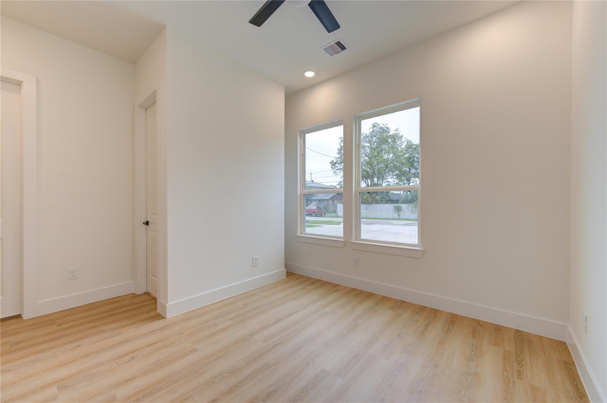 4029 Knoxville Street, Unit B Houston, TX 77051 - Photo 24 of 33 wooden floor in an empty room with a window