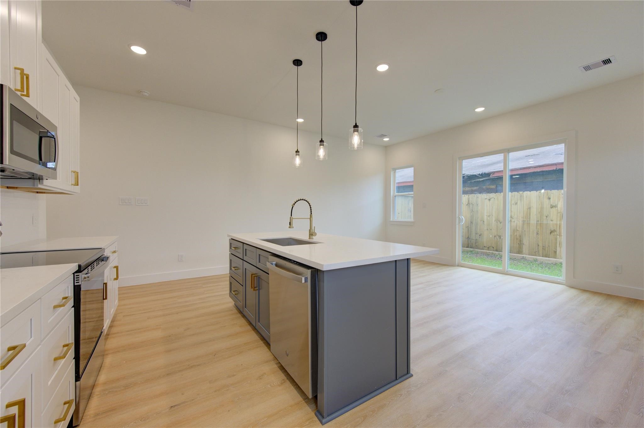 4029 Knoxville Street, Unit B Houston, TX 77051 - Photo 3 of 33 a kitchen with stainless steel appliances granite countertop a sink a stove and a wooden floors