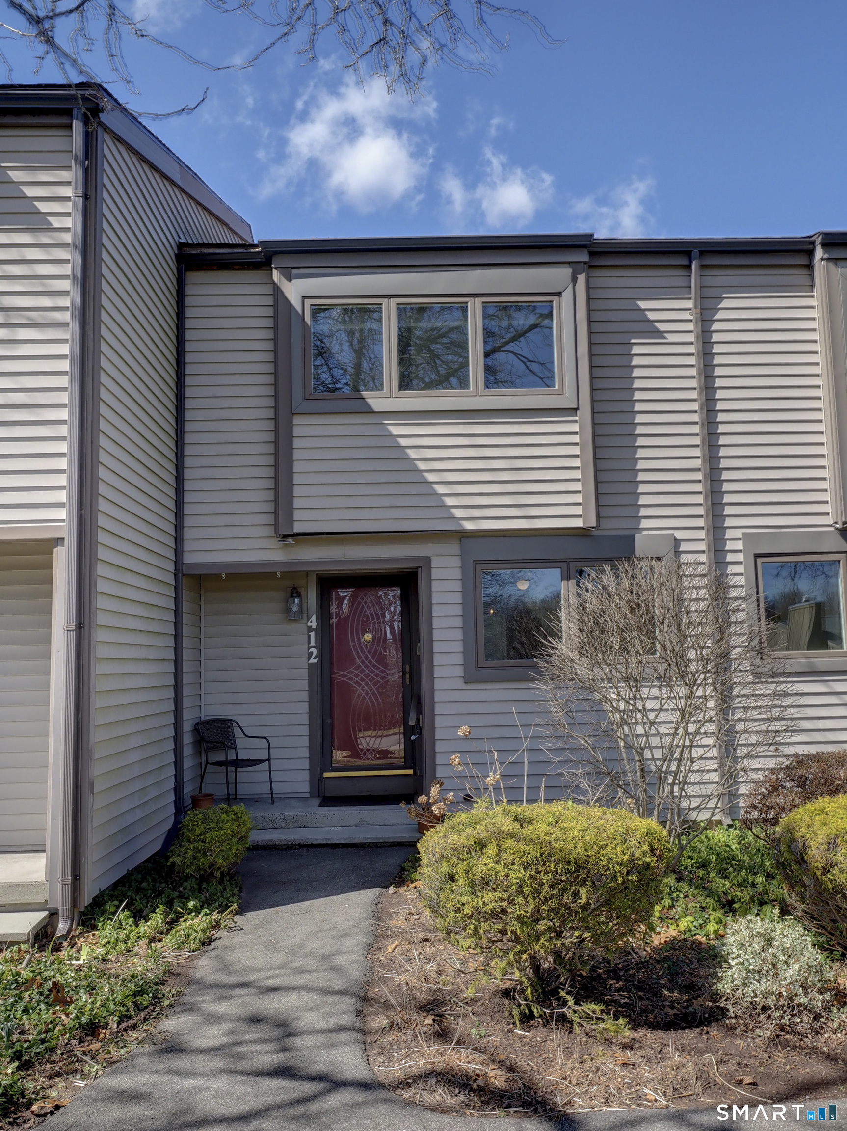 412 Pilgrims Harbor, Unit 412 Wallingford, CT 06492 - Photo 1 of 22 a front view of a house with garden