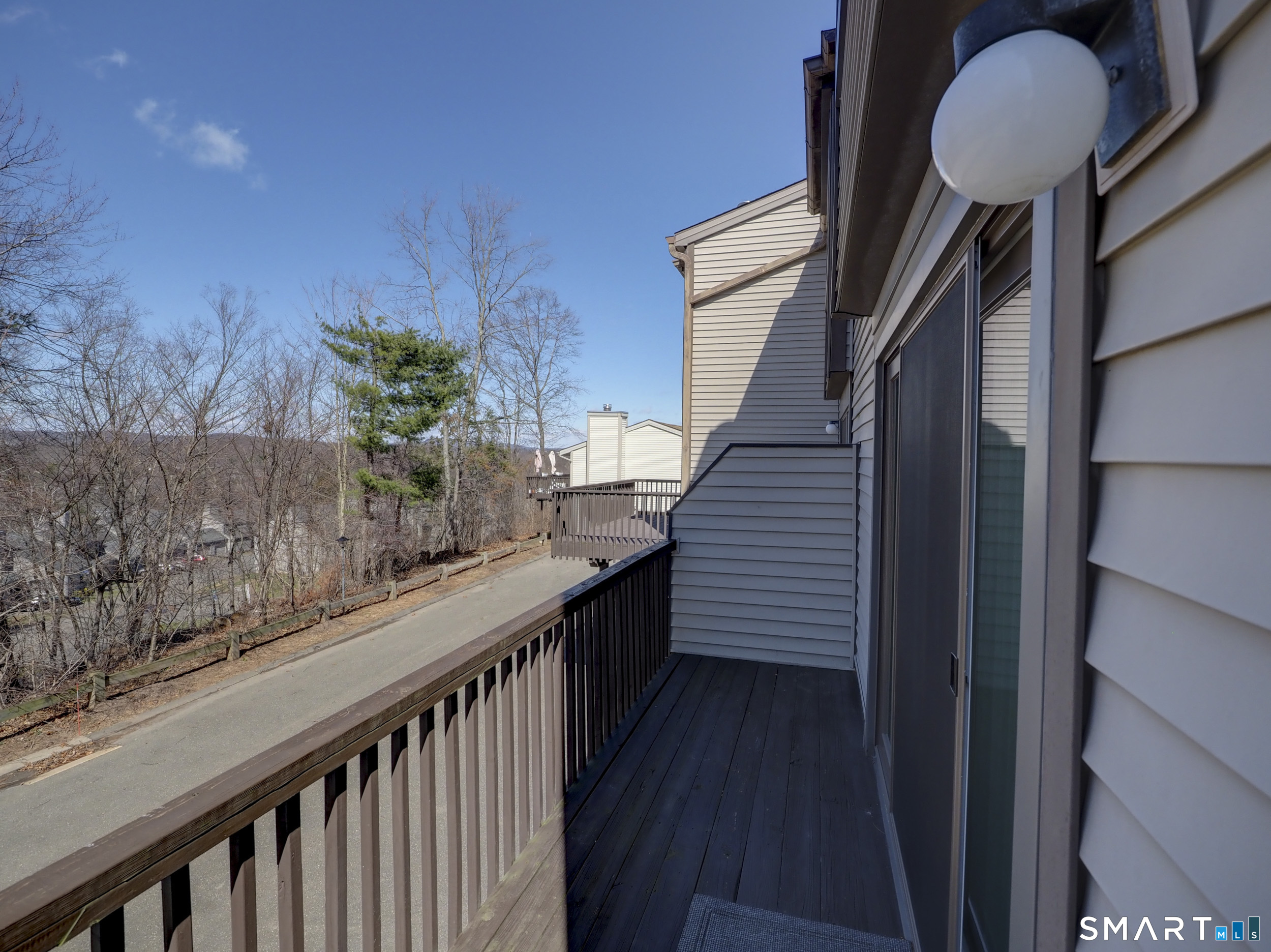 412 Pilgrims Harbor, Unit 412 Wallingford, CT 06492 - Photo 13 of 22 a view of a balcony with wooden floor and potted plants