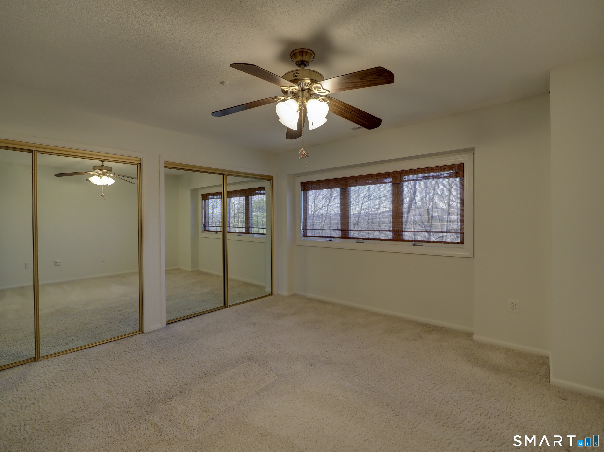 412 Pilgrims Harbor, Unit 412 Wallingford, CT 06492 - Photo 15 of 22 a view of an empty room with chandelier fan and a window