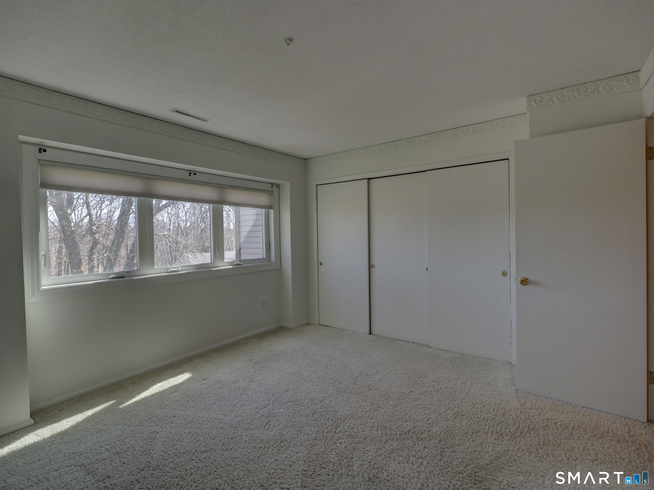 412 Pilgrims Harbor, Unit 412 Wallingford, CT 06492 - Photo 18 of 22 a view of an empty room with a window
