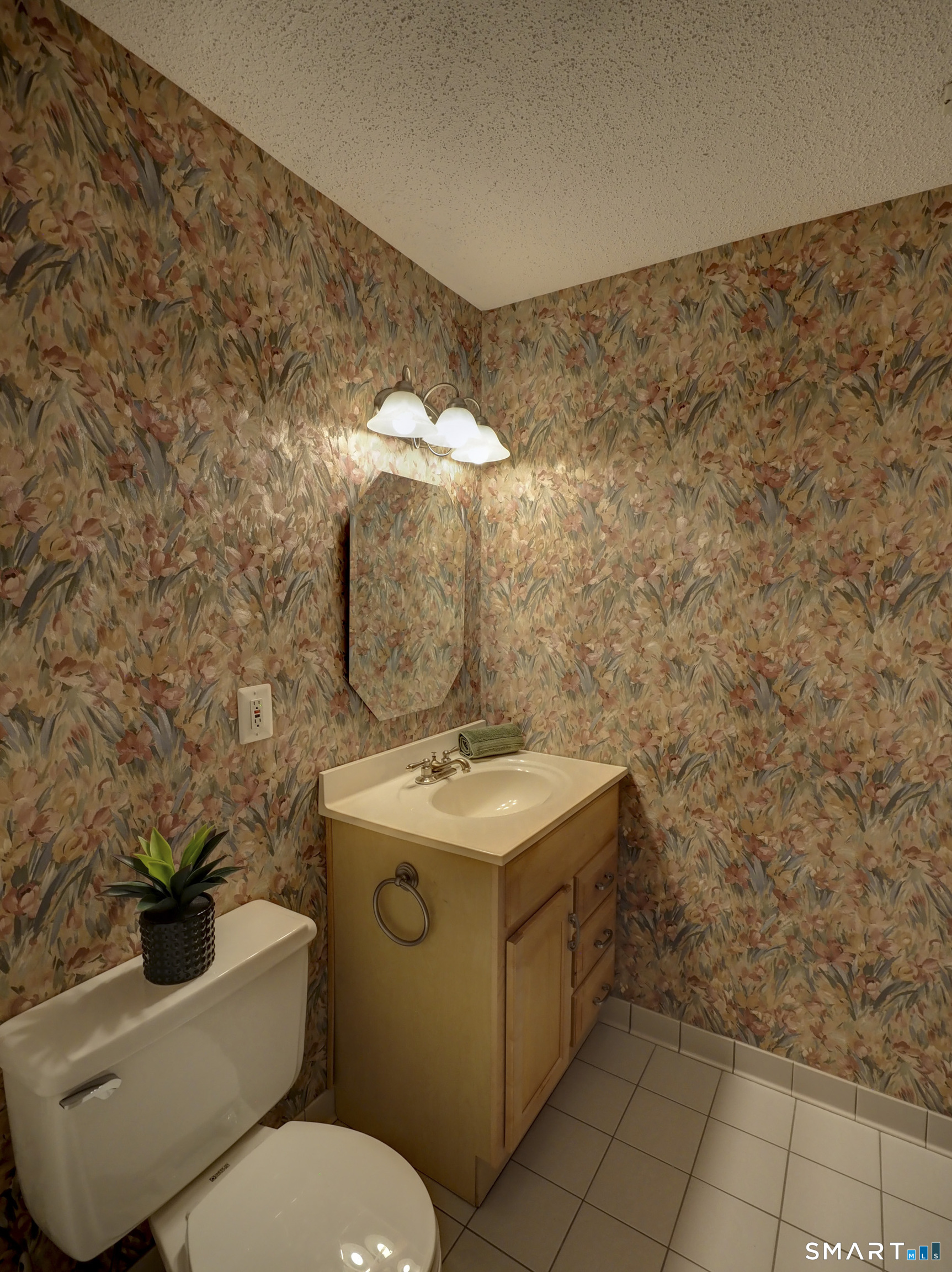 412 Pilgrims Harbor, Unit 412 Wallingford, CT 06492 - Photo 19 of 22 a bathroom with a toilet sink and mirror