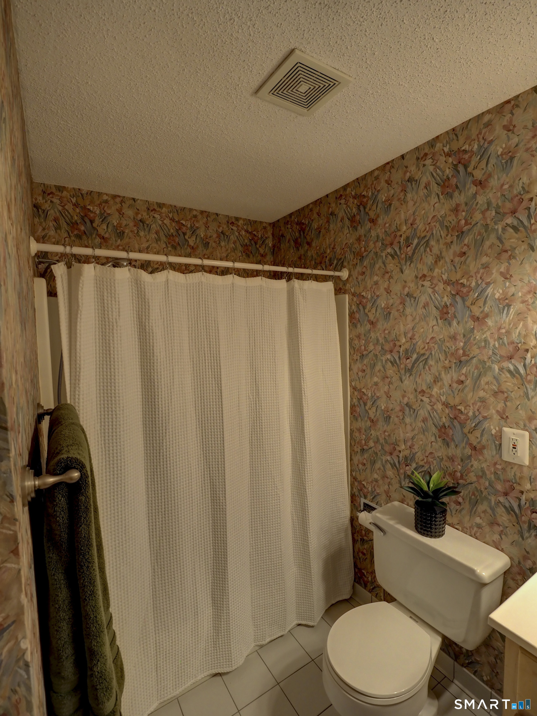 412 Pilgrims Harbor, Unit 412 Wallingford, CT 06492 - Photo 20 of 22 a bathroom with a shower curtain and toilet
