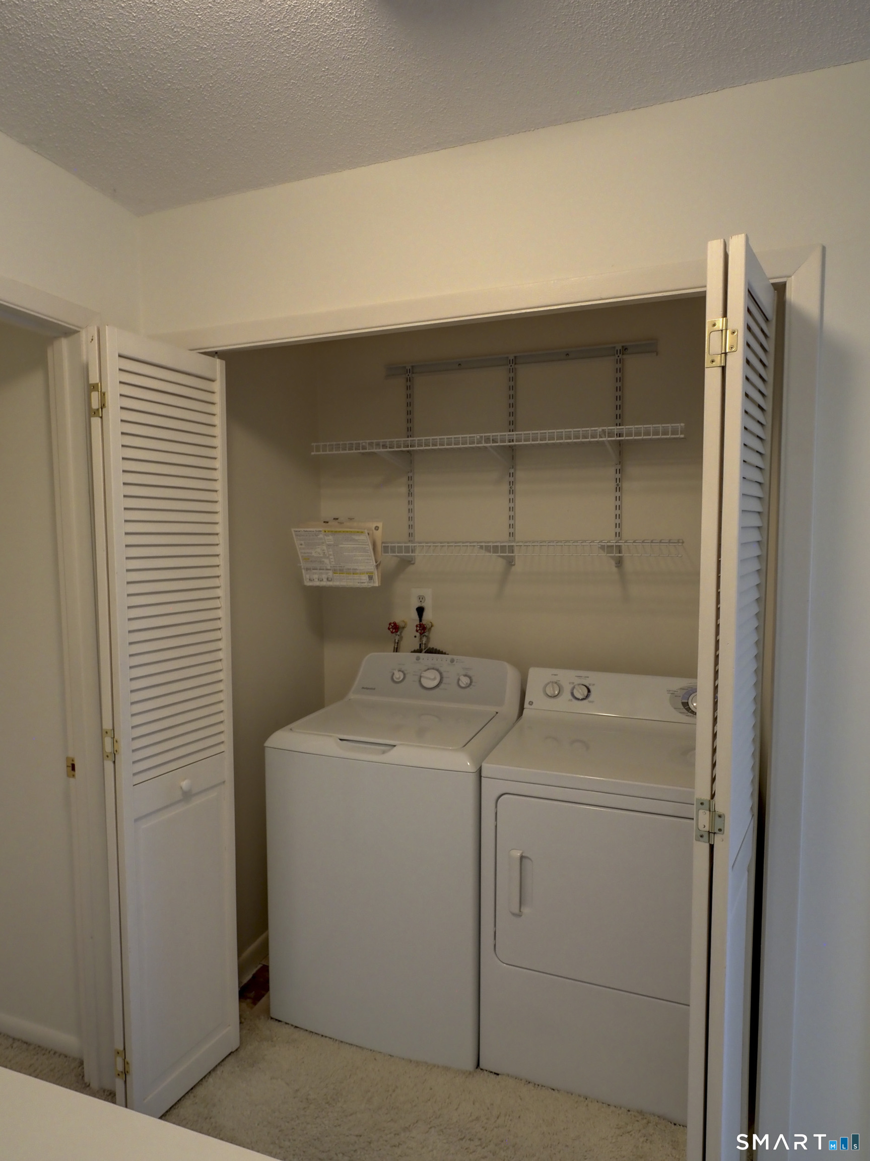 412 Pilgrims Harbor, Unit 412 Wallingford, CT 06492 - Photo 21 of 22 a utility room with dryer and washer