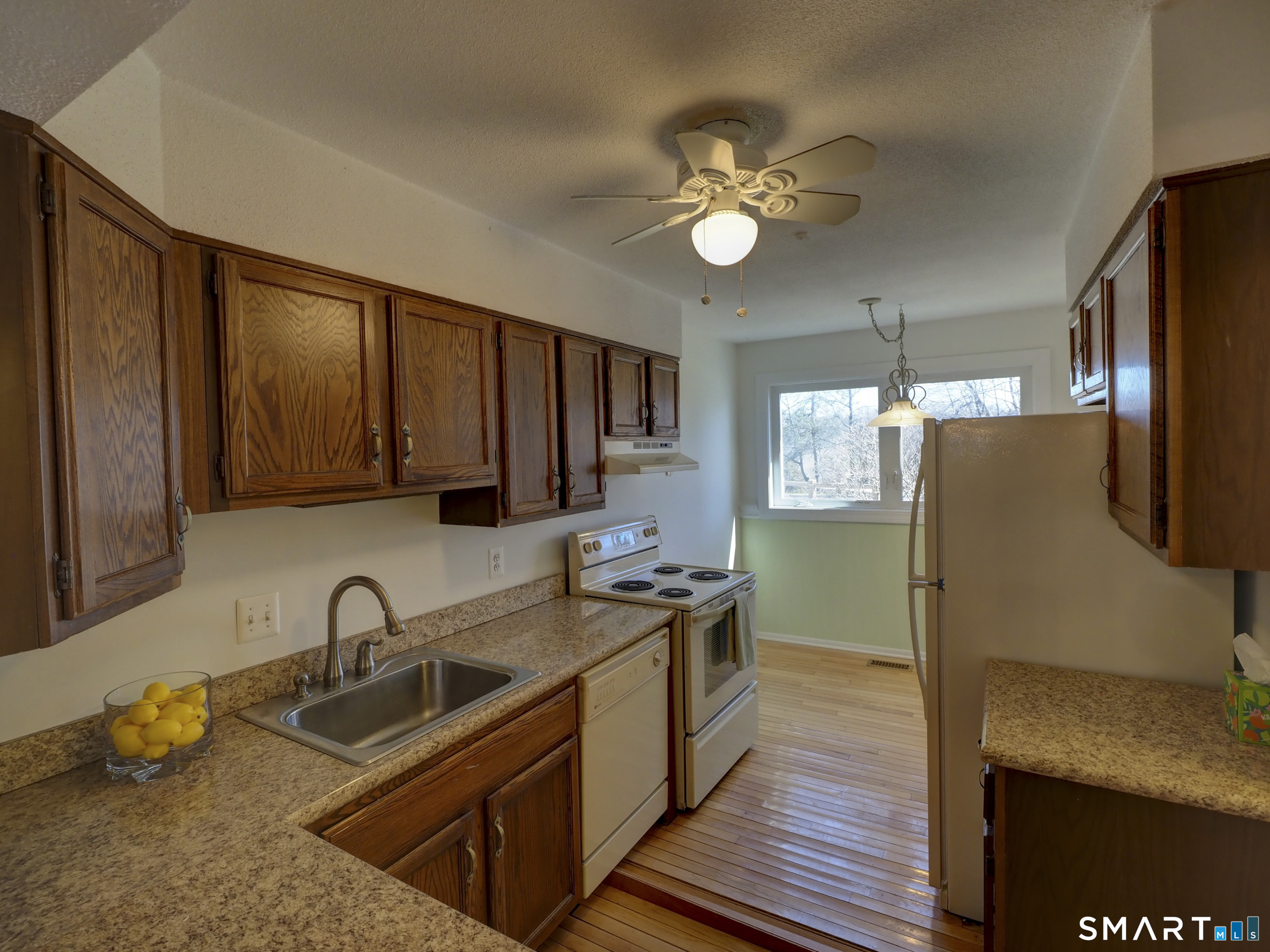 412 Pilgrims Harbor, Unit 412 Wallingford, CT 06492 - Photo 3 of 22 a kitchen that has a sink stainless steel appliances and cabinets