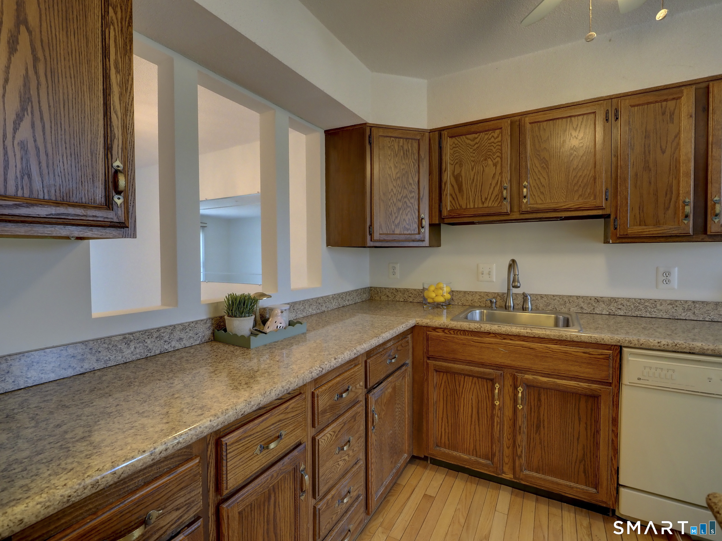 412 Pilgrims Harbor, Unit 412 Wallingford, CT 06492 - Photo 4 of 22 a kitchen with stainless steel appliances granite countertop wooden cabinets a sink and dishwasher