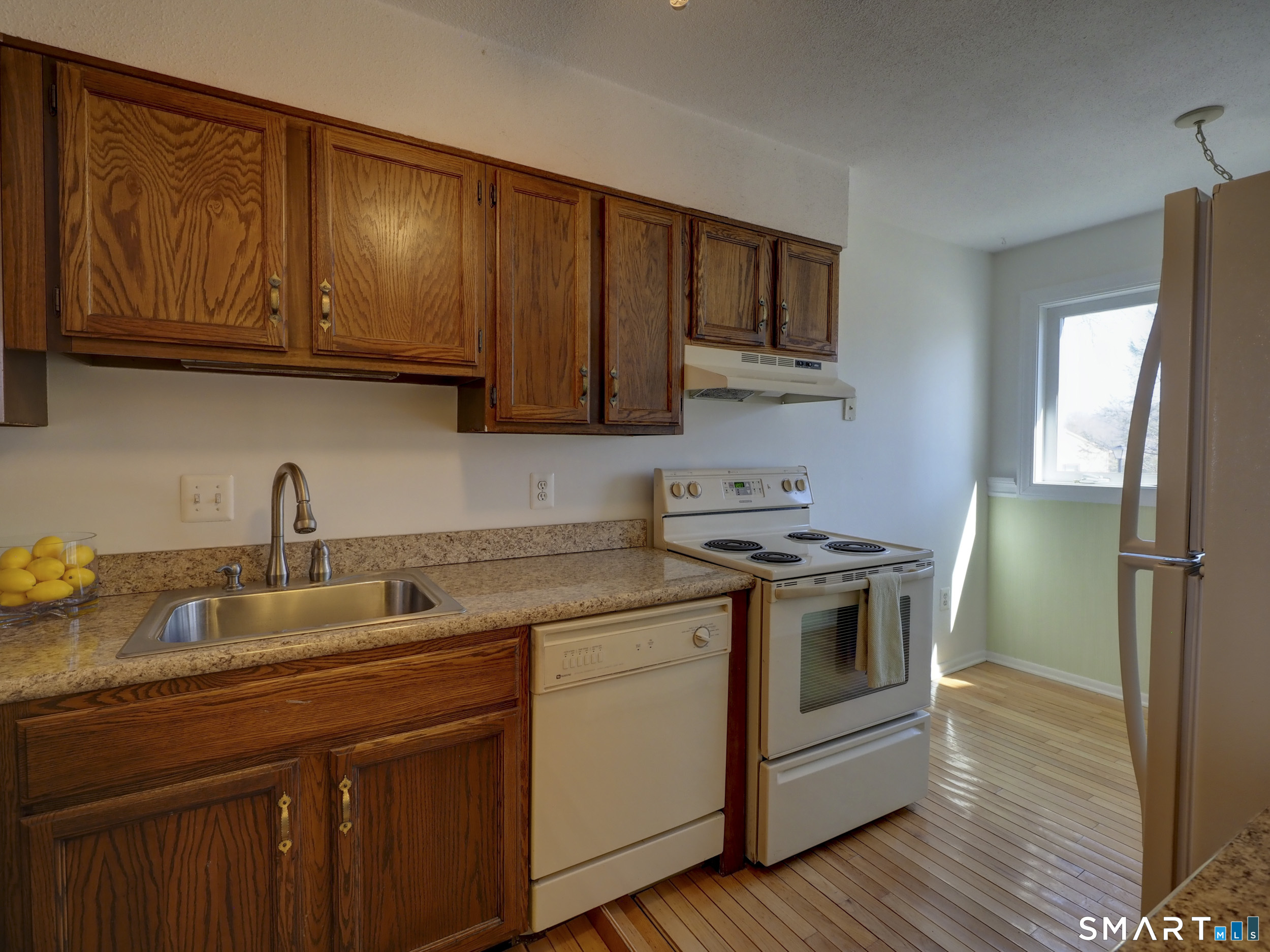 412 Pilgrims Harbor, Unit 412 Wallingford, CT 06492 - Photo 5 of 22 a kitchen with stainless steel appliances granite countertop a sink stove and cabinets