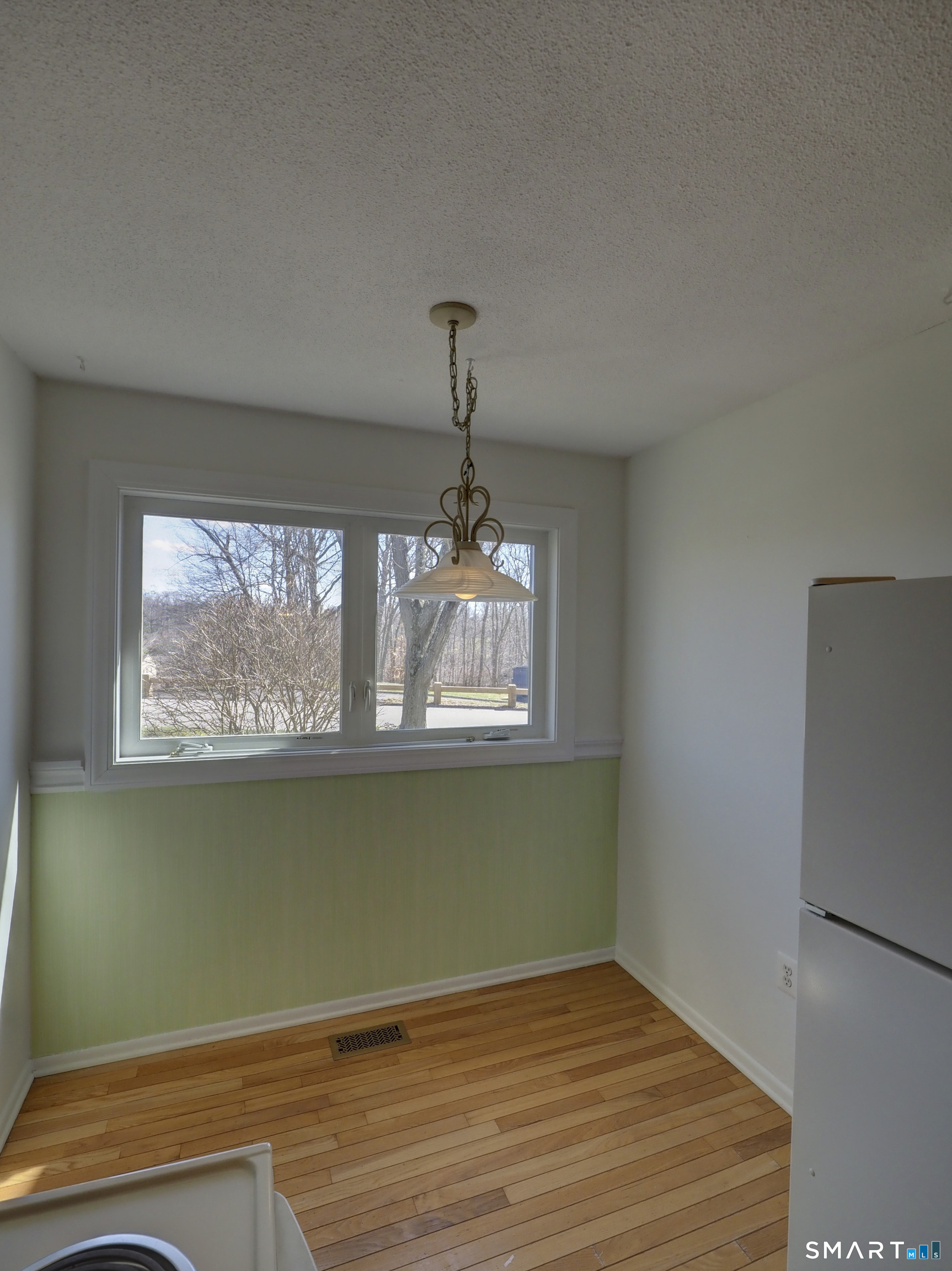 412 Pilgrims Harbor, Unit 412 Wallingford, CT 06492 - Photo 6 of 22 a view of a room with wooden floor and fan