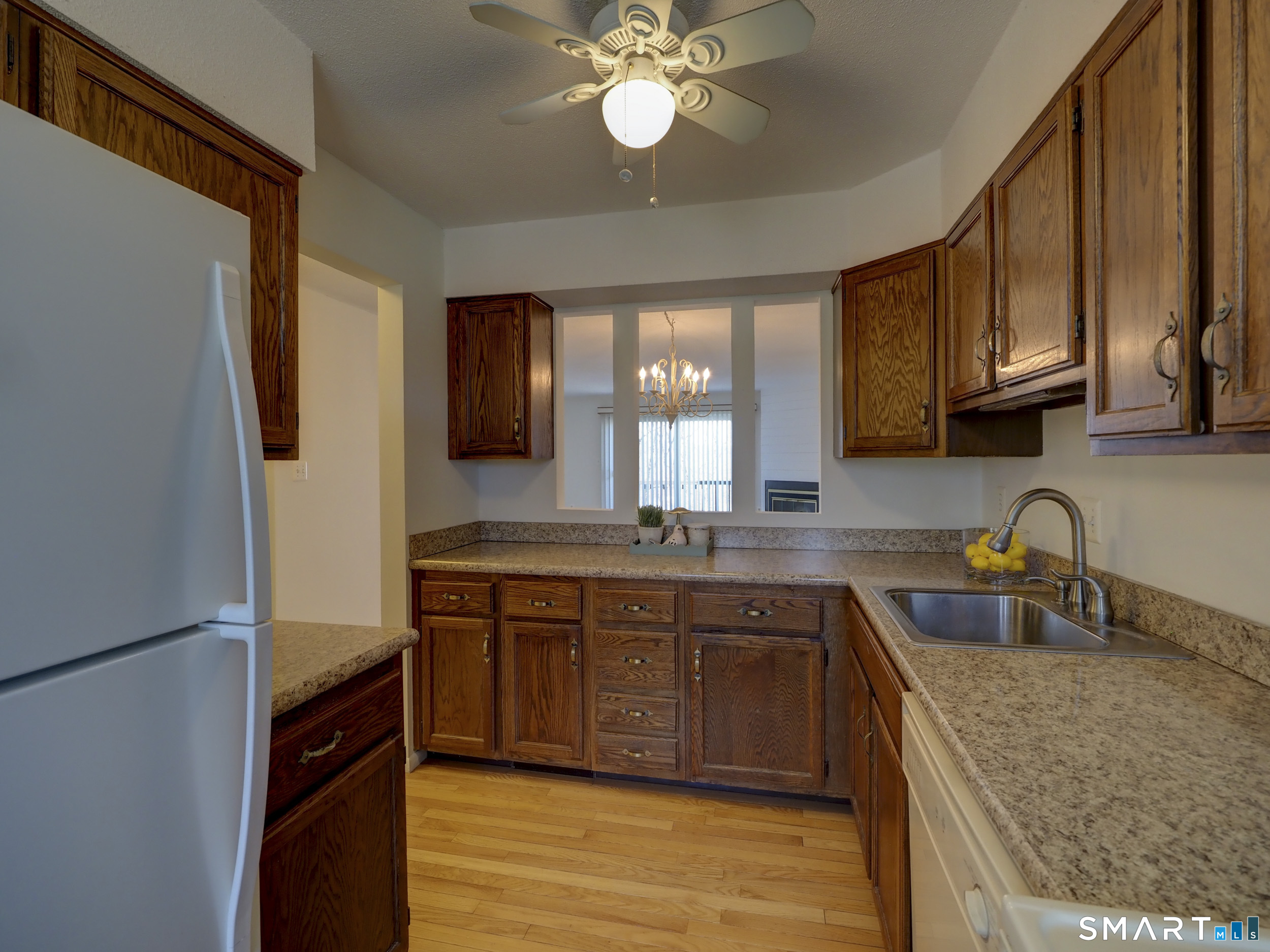 412 Pilgrims Harbor, Unit 412 Wallingford, CT 06492 - Photo 7 of 22 a kitchen with a sink stove and cabinets