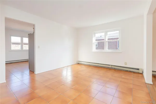 an empty room with windows and closet