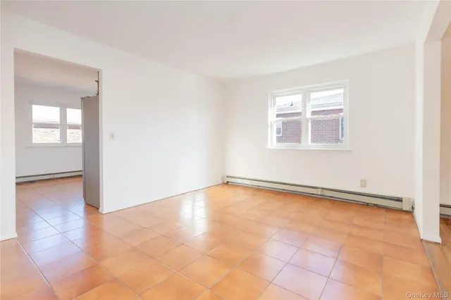 an empty room with windows and closet