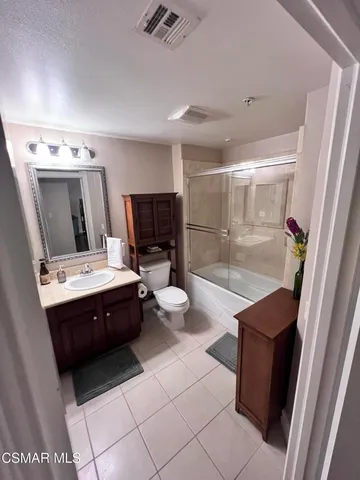 a bathroom with a sink vanity and a mirror