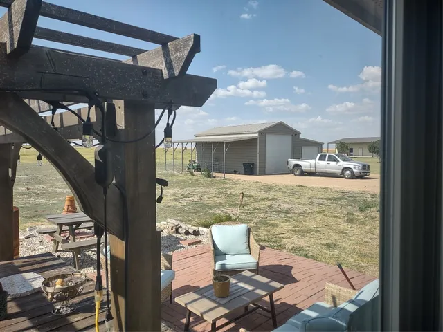a roof deck with table and chairs a barbeque
