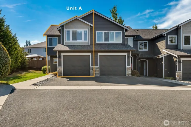 a front view of a house with a yard and garage