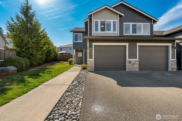 a front view of a house with a yard and garage